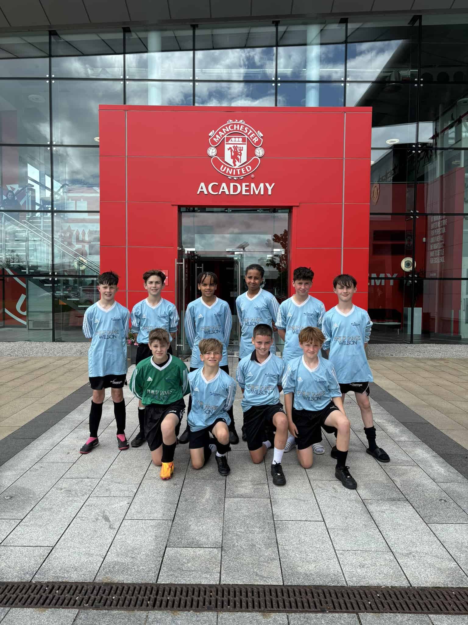 Priestnall School Year 7 football team outside of Man Utd Academy for the MU Emerging Talent Final 2024