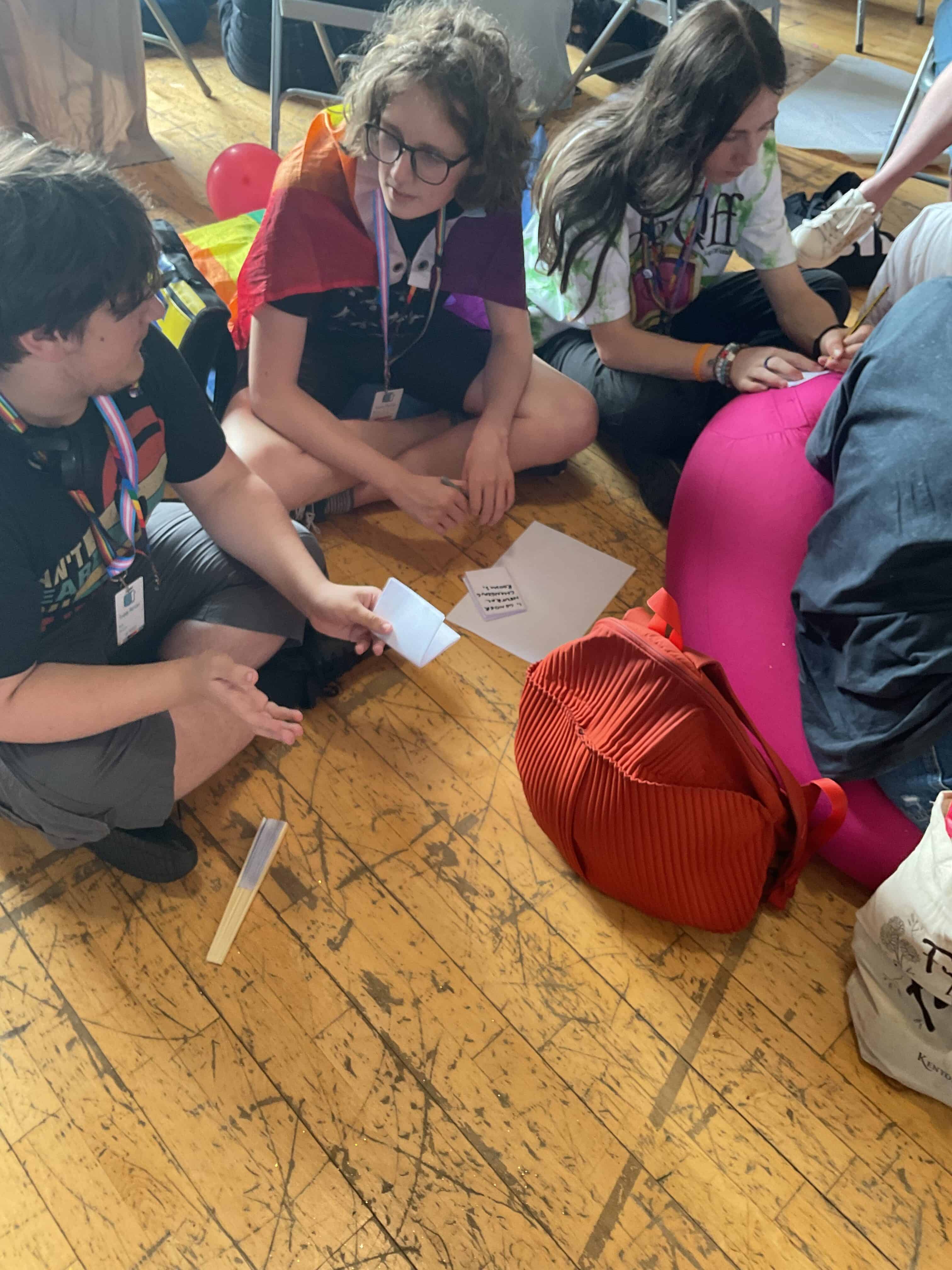 Students from Priestnall School take part in an activity, writing on cards sat on the floor at the Proud Trust LGBT+ Youth Summit.