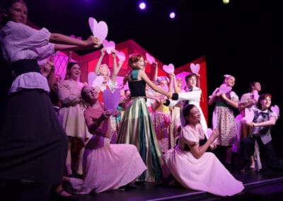 Priestnall School students hold hearts during a song in the Frozen Jr School Production.