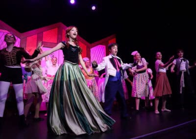 A big group of students, including Anna, perform a musical number in the Priestnall School Frozen Jr Production.