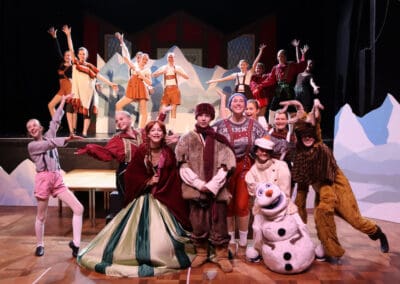 The main cast of the Priestnall School Frozen Jr Production all stand together posing.