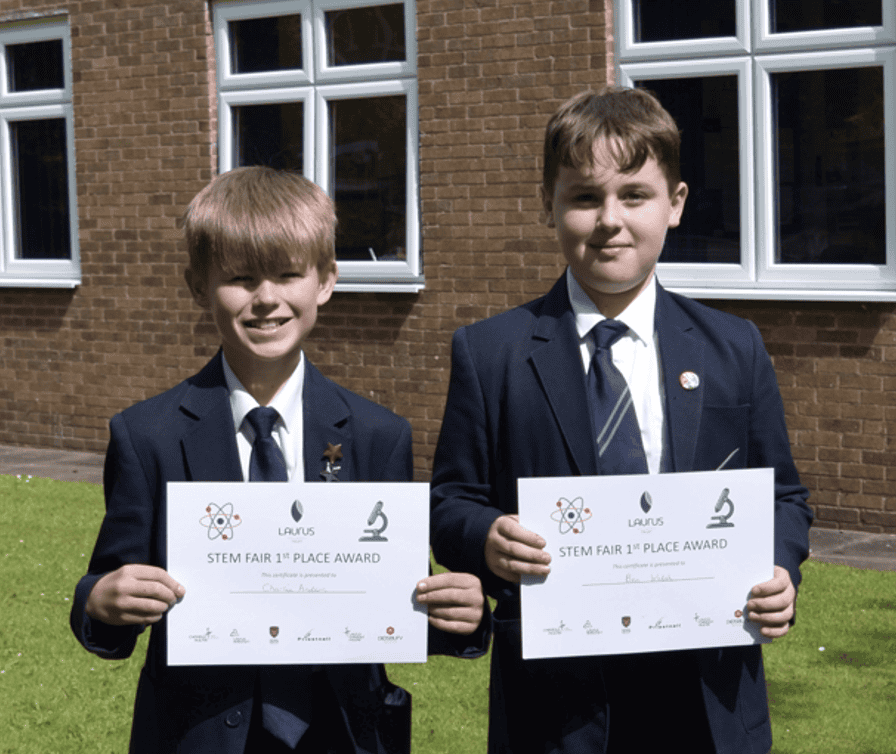 Students holding their certificates after winning the Laurus Trust Science Fair.