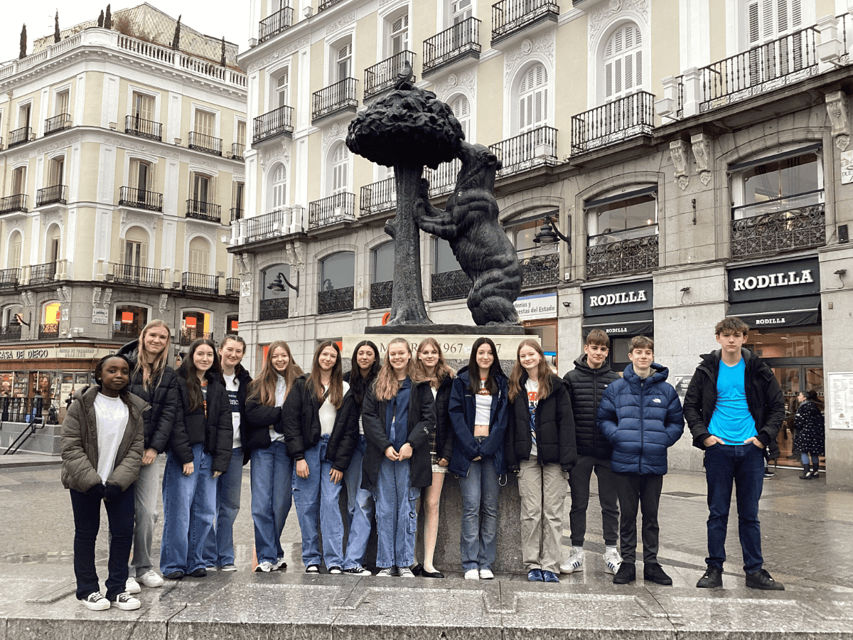 Students from Priestnall School stand in front of a sculpture at Puerta Del Sol.